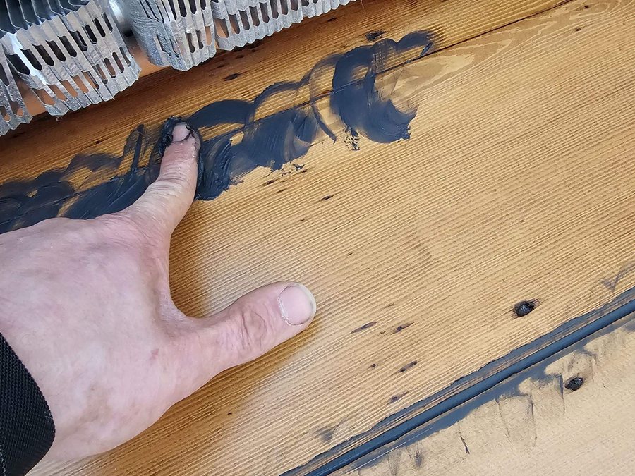 Filling seams between hemlock boards by hand before finishing